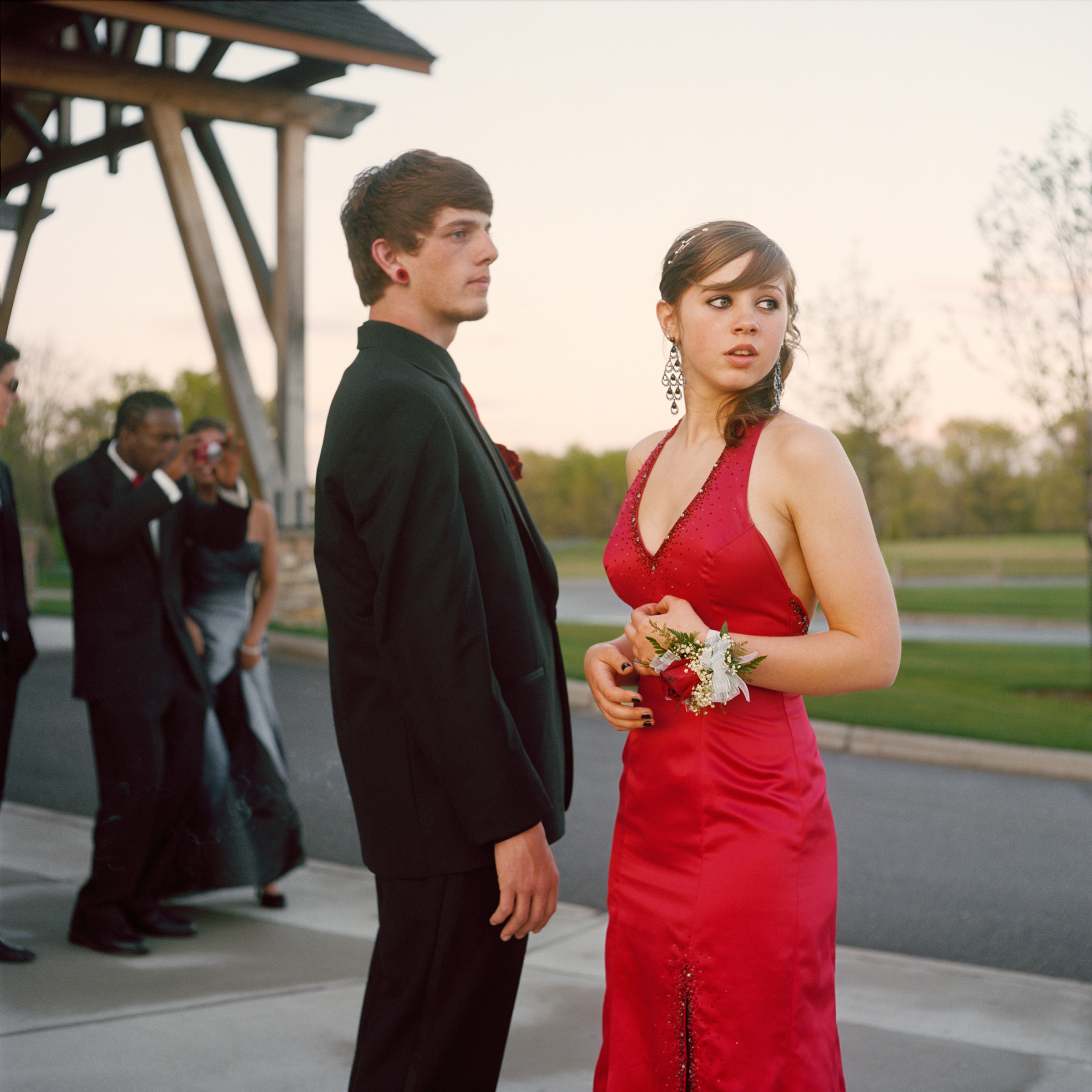 <strong>In 2014, the average cost for a prom dress was $195, according to <a href="http://www.statisticbrain.com/prom-night-statistics/" title="Statistic Brain" target="_blank">Seventeen Magazine</a>. On top of this, a teen girl's prom expenses include shoes, handbag, hair, makeup, manicure and jewelry. However, teen boys are often expected to bear the costs for many prom activities, and the average costs of a limousine for four hours can be $450 and prom tickets can be $75. This excludes his tuxedo, accessories, their dinner and transportation. For help making a budget, get the <a href="http://www.practicalmoneyskills.com/resources/prom2014.php" title="Visa Plan'it Prom app" target="_blank">Visa Plan'it Prom app</a>.</strong>
Title: "Nick and Angel," from the series <em><a href="http://amyandersonart.com/crossroads.htm" title="At Risk, With Promise" target="_blank">At Risk, With Promise.</a></em>
<a href="http://amyandersonart.com/" title="Amy Anderson" target="_blank">Amy Anderson</a> has been documenting students at Crossroads Alternative High School for the last four years. Coming from diverse backgrounds, they have been unable to be successful in a traditional school setting for various reasons. Some are brilliant, kind, articulate teenagers; some are abused, addicted, angry youth…many are both. Though they carry the wounds and fears of their past, her portraits honor the strength that develops as they begin a new journey and make changes and choices that will shape their lives.