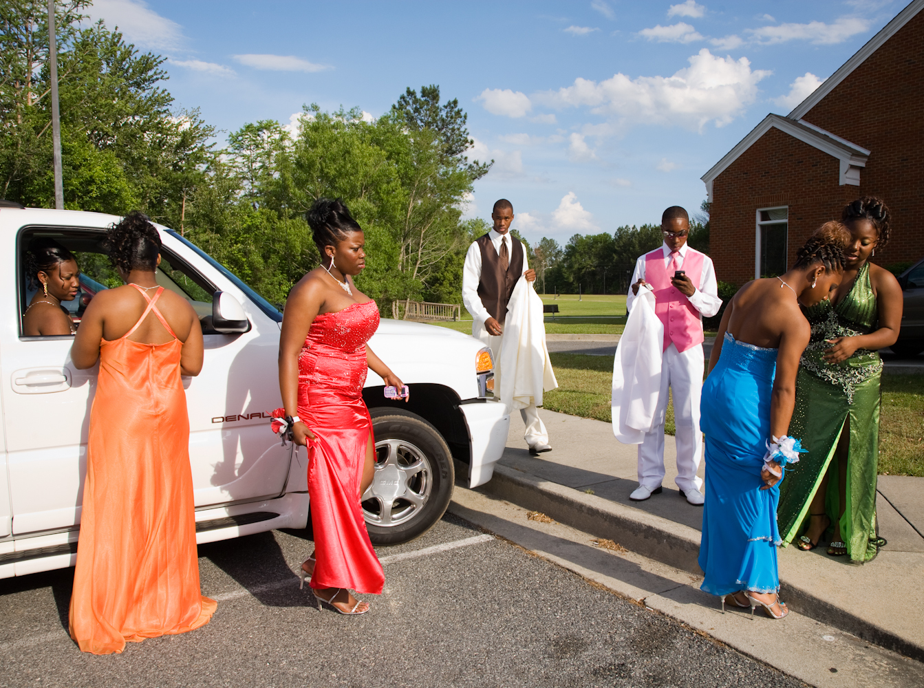 <strong>On average, in 2014, Southern families spent nearly $200 less on prom-related costs than the Northeast and West Coasts, the <a href="http://www.practicalmoneyskills.com/resources/pdfs/Visa_Prom_Survey_2014.pdf" title="2014 Visa Prom Spending Survey" target="_blank">2014 Visa Prom Spending Survey</a> discovered. The American average household spending on the annual high school rite of passage was $978. Parents were planning to pay for 56% of prom costs, while their teens covered the remaining 44%. </strong>
Title: "Parking Lot of the First Integrated Prom, Lyons, Georgia 2010," from the series <a href="http://www.gillianlaub.com/#/Works%20and%20Projects/Southern%20Rites/1/" title="Southern Rites" target="_blank">Southern Rites.</a>
For more than five years, <a href="http://www.gillianlaub.com/" title="Gillian Laub" target="_blank">Gillian Laub</a> has photographed Mt. Vernon, a town in Georgia where—despite the integration of its schools in 1971—the high school's fall homecoming and spring prom remain racially segregated. In 2009, <a href="http://www.nytimes.com/interactive/2009/05/24/magazine/dividedproms-audioss/" title="New York Times Magazine – A Prom Divided" target="_blank">The New York Times Magazine published some of these images in a photo essay and multimedia piece, "A Prom Divided."</a> It caused national outrage. Now, there is only one homecoming queen and one prom.