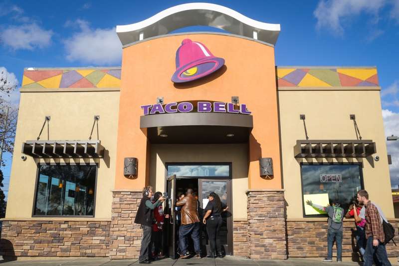 OAKLAND, CA - DECEMBER 4: Protesters enter a Taco Bell as part of a demonstration for higher wages and better security for fast food workers on December 4, 2014 in Oakland, California. The Taco Bell has been the victim of numerous violent robberies but has no security guard. The protest was part of a nationwide day of demonstrations. (Photo by Elijah Nouvelage/Getty Images)