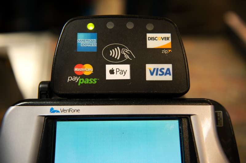 NEW YORK, NY - OCTOBER 20: Apple Pay is promoted on signs placed at the cash register of Whole Foods in Columbus Circle on October 20, 2014 in New York, NY. The software, which debuted today, is available in the recently updated iPhone 6 software and accepted in 220,000 stores. It allows iPhone users to pay for purchases using their iPhone's NFC capabilities instead of using their credit card. (Photo by Bryan Thomas/Getty Images)