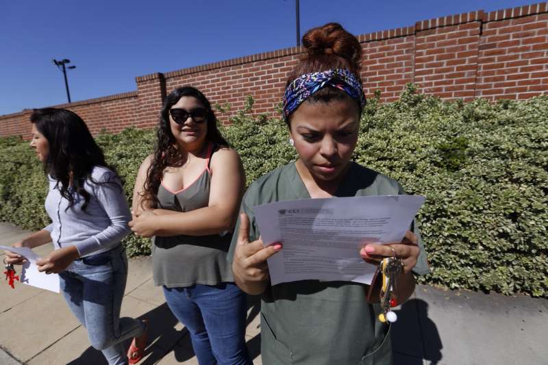 Ruby Maldanado, 20, a Medical Assistant student checks a note handed out to students that have been turned away at the gate to Everest College on April 27, 2015 in Alhambra, California. Corinthian Colleges Inc., a Santa Ana company that was once one of the nation's largest for-profit college chains, announced that it would be shutting down its remaining two dozen schools effective - a move that leaves 16,000 students scrambling for alternatives.