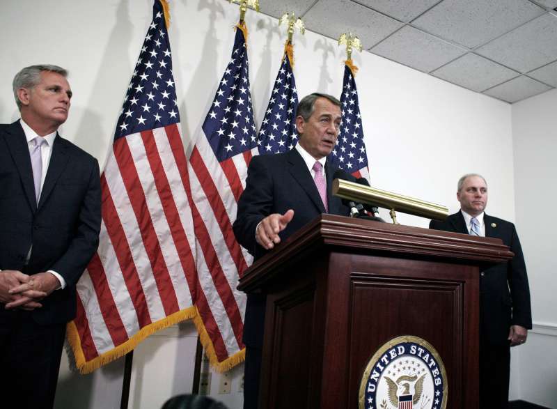Outgoing House Speaker John Boehner of Ohio, center, flanked by House Majority Leader Kevin McCarthy of California, left, and House Majority Whip Steve Scalise of Louisiana, talks with reporters on Capitol Hill in Washington, October 27, 2015. House Republican leaders on Tuesday pushed toward a vote on a two-year budget deal despite conservative opposition, relying on the backing of Democrats for the far-reaching pact struck with President Barack Obama.