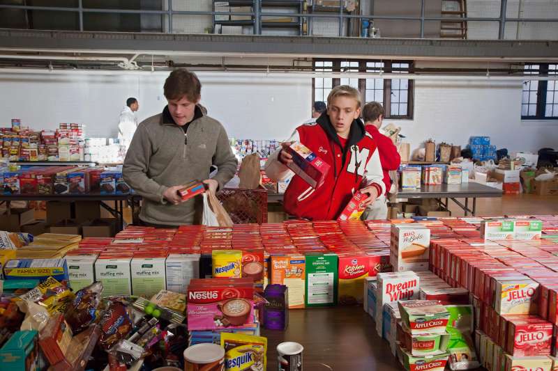 Volunteers from Orchard Lake St. Mary's, a Catholic boys school in Pontiac, Michigan, sort donated food which will be distributed to low-income families for Thanksgiving, November 18, 2011. The annual food distribution is organized by Lighthouse of Oakland County, a social services agency.
