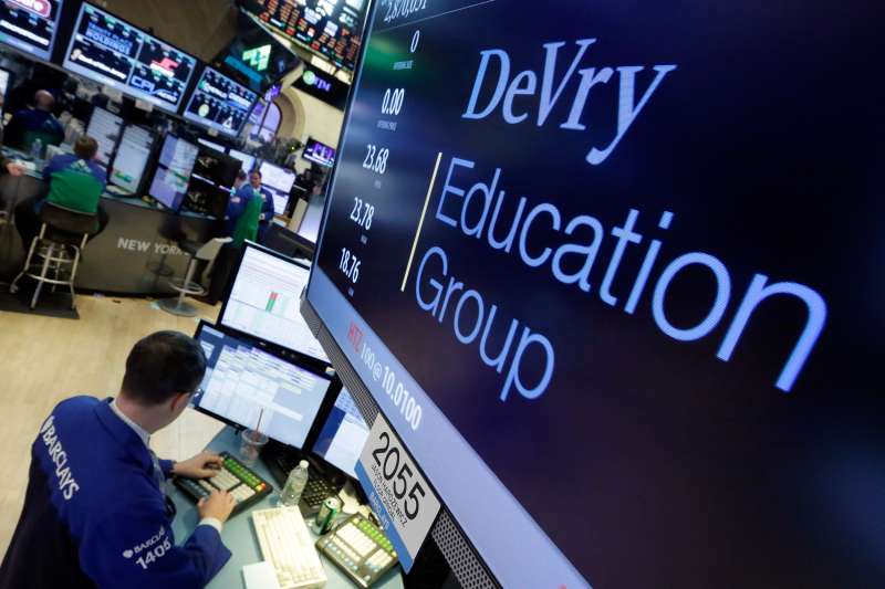 Specialist Neil Gallagher works at the post that handles DeVry Education Group, on the floor of the New York Stock Exchange, January 27, 2016. The government is suing the operators of the for-profit DeVry University, alleging they misled consumers about students' jobs and earnings prospects.