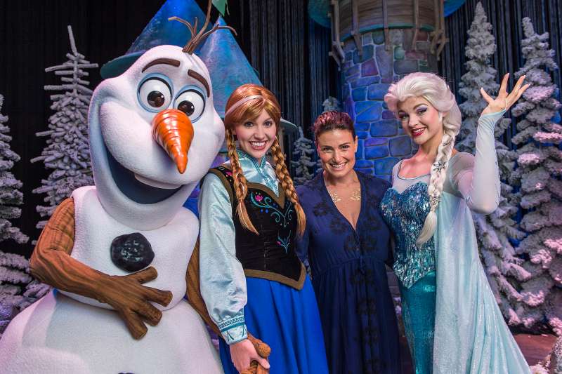 In this handout image provided by Disney Parks, Tony Award-winning actress and singer Idina Menzel poses on July 28, 2015 with Elsa, Anna and Olaf from Disney's Frozen during Frozen Summer Fun at Disney's Hollywood Studios theme park in Lake Buena Vista, Florida. Menzel took a break from her world tour to visit Walt Disney World Resort.