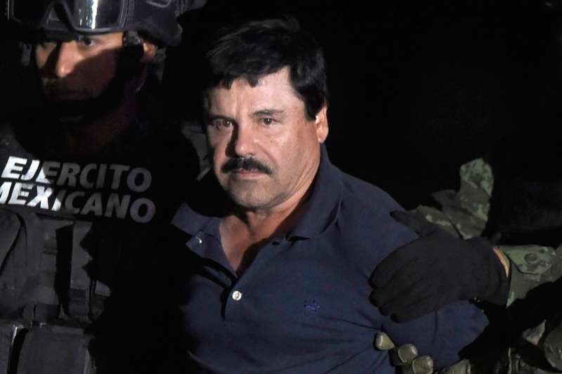 Drug kingpin Joaquin El Chapo Guzman is escorted to a helicopter at Mexico City's airport on January 8, 2016 following his recapture during an intense military operation in Los Mochis, in Sinaloa State. Mexican marines recaptured fugitive drug kingpin Joaquin El Chapo Guzman in the northwest of the country, six months after his spectacular prison break embarrassed authorities.
