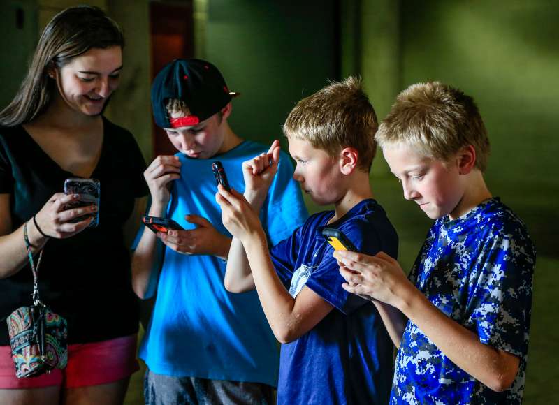 Youngsters play during a Pokemon Go event at Memorial Stadium in Lincoln, Neb., Thursday, July 14, 2016. Nebraska Athletic Department officials opened Memorial Stadium for two hours Thursday to accommodate Pokemon Go players eager to capture animated monsters at the venerated field.