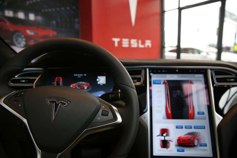 The inside of a Tesla vehicle is viewed as it sits parked in a new Tesla showroom and service center in Red Hook, Brooklyn on July 5, 2016 in New York City. The electric car company and its CEO and founder Elon Musk have come under increasing scrutiny following a crash of one of its electric cars while using the controversial autopilot service. Joshua Brown crashed and died in Florida on May 7 in a Tesla car that was operating on autopilot, which means that Brown's hands were not on the steering wheel.
