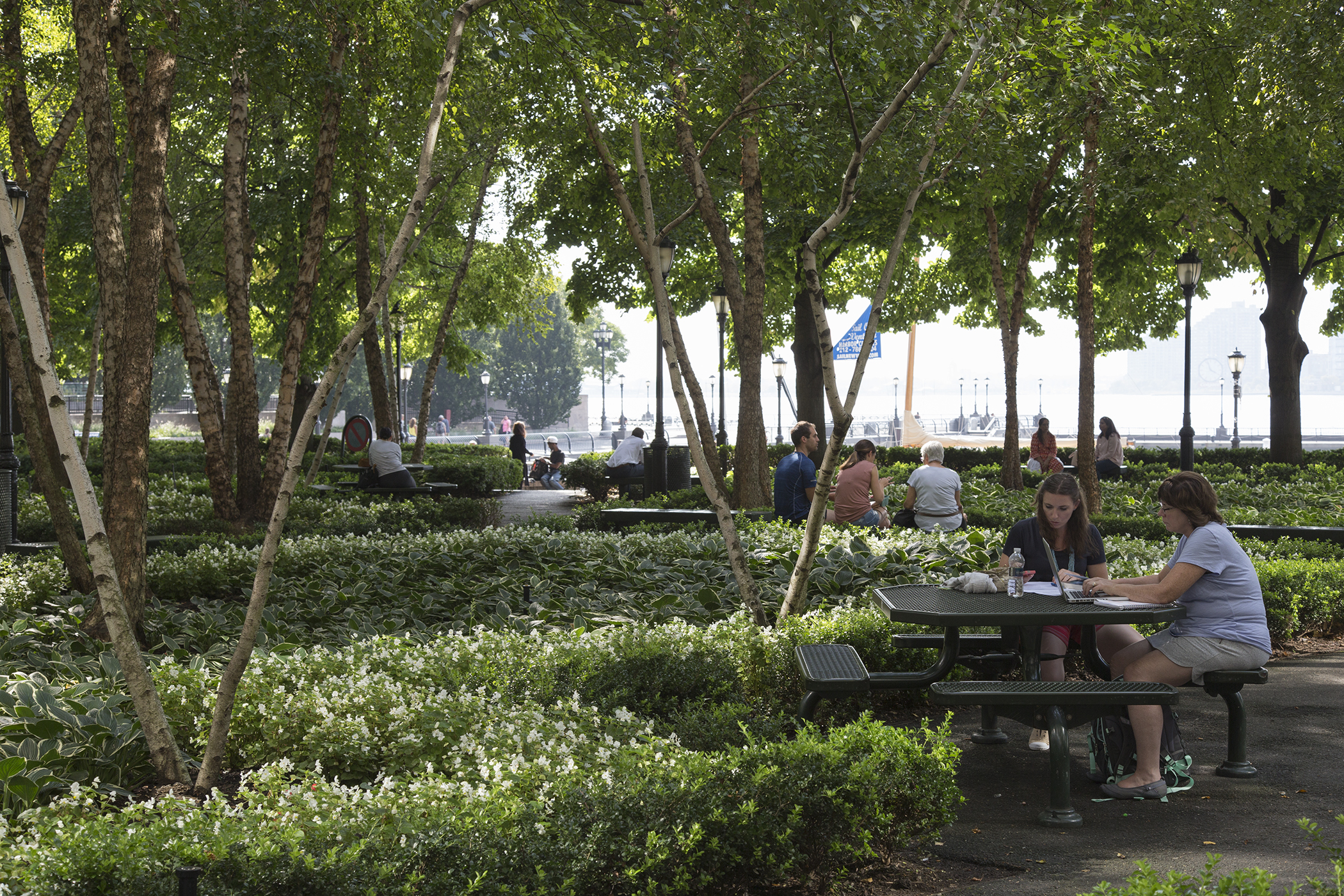 Freelancers work outdoors in Waterfront Plaza adjacent to Brookfield Place, New York.