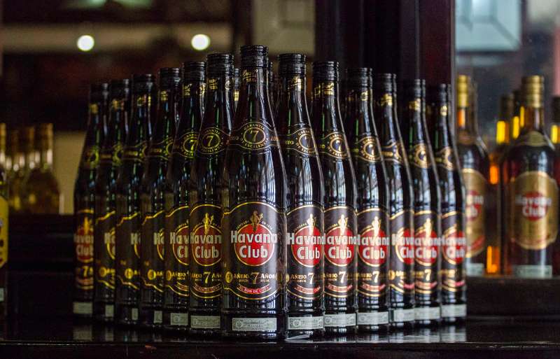 This June 8, 2016 file photo shows bottles of Cuban Havana Club rum displayed on the bar at the Rum Museum in Havana, Cuba. The Obama administration announced Friday, Oct. 14, 2016 it is eliminating a $100 limit on the value of Cuban rum and cigars that American travelers can bring back from the island.