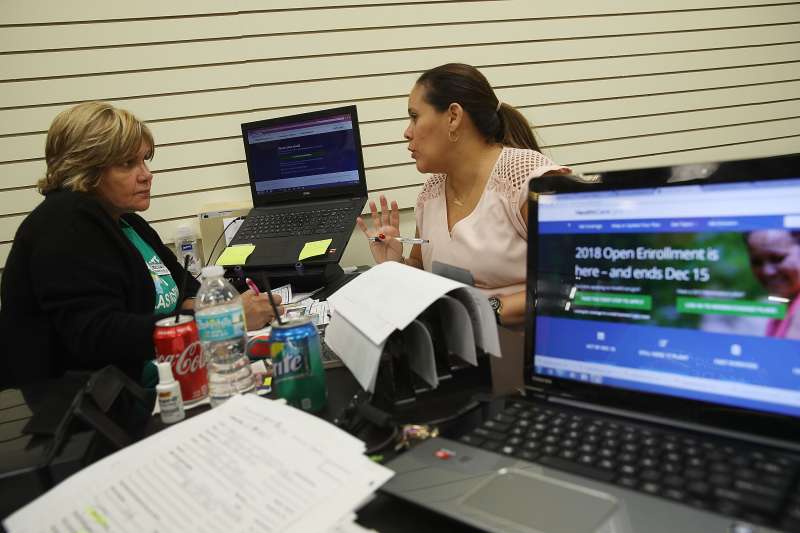 Margarita Mills (L), an insurance agent from Sunshine Life and Health Advisors, speaks with Daniela Morales as she shops for insurance under the Affordable Care Act at a store setup in the Mall of Americas on November 1, 2017 in Miami, Florida. The open enrollment period to sign up for a health plan under the Affordable Care Act started today and runs until Dec. 15.