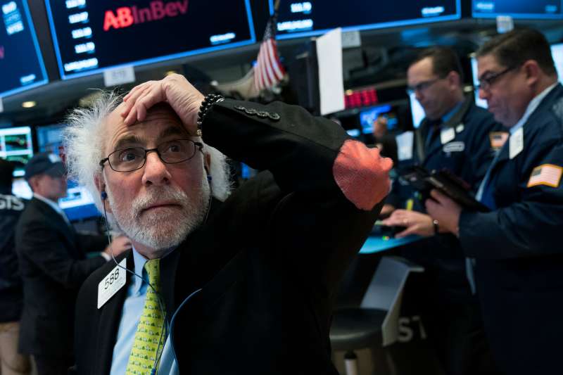 Traders and financial professionals work on the floor of the New York Stock Exchange (NYSE) at the closing bell, February 2, 2018 in New York City. The Dow dropped 250 points at the open on Friday morning. The Dow plunged over 660 points on Friday, marking its biggest one day plunge since June 2016 following the Brexit vote.