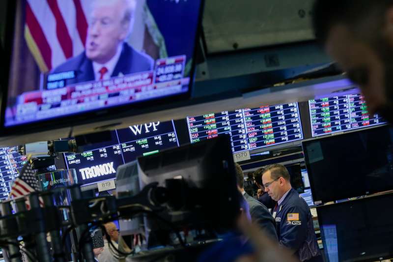 Traders work on the floor of the New York Stock Exchange (NYSE) as U.S. President Donald Trump is seen on TV on March 1, 2018 in New York City. Major stock indexes plunged Thursday afternoon following President Trump's announcement that he was imposing a 25 percent tariff on imported steel and 10 percent on aluminum. Investor concern about the news rattled the Dow Jones industrial average, which closed down more than 400 points.