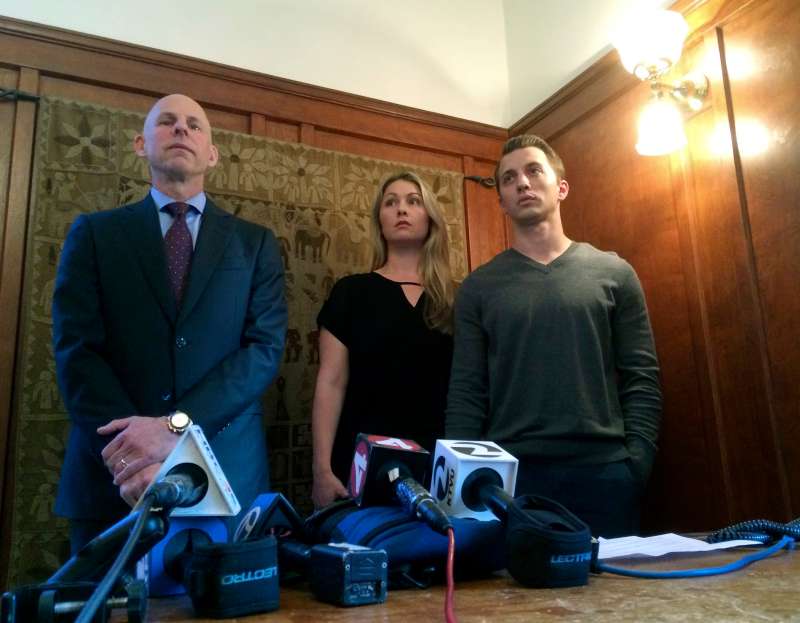 Attorney Anthony Douglas Rappaport, left, speaks at a news conference with his clients, Denise Huskins and her boyfriend Aaron Quinn, right, in San Francisco. The couple that police detectives wrongly accused of fabricating the woman's kidnapping from their home has reached a $2.5 million settlement with the city of Vallejo and its police department.