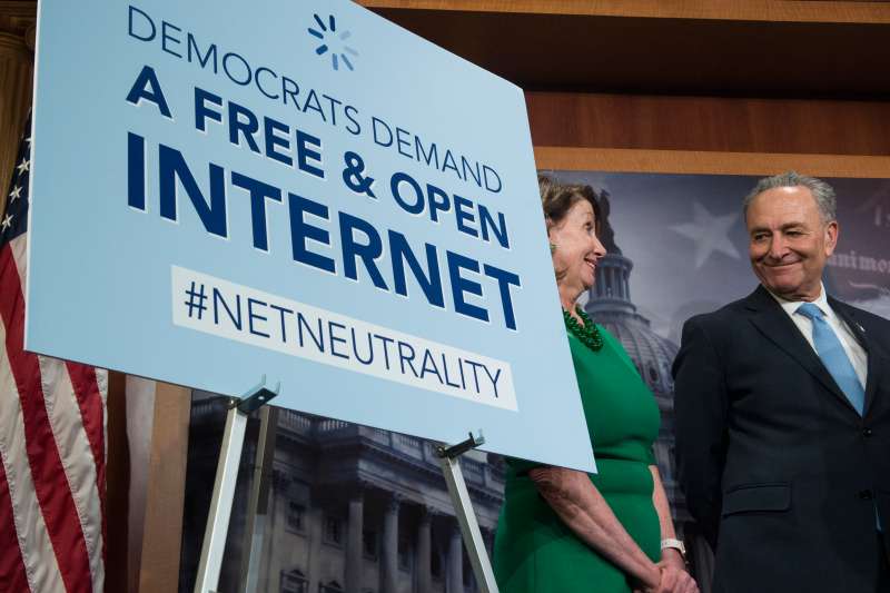 Senate Minority Leader Sen. Charles Schumer, D-NY, and House Minority Leader Nancy Pelosi smile during a press conference following the vote that would help stop the Federal Communications Commission's effort to reverse Obama-era regulations on net neutrality May 16, 2018. (Photo By Sarah Silbiger/CQ Roll Call)
