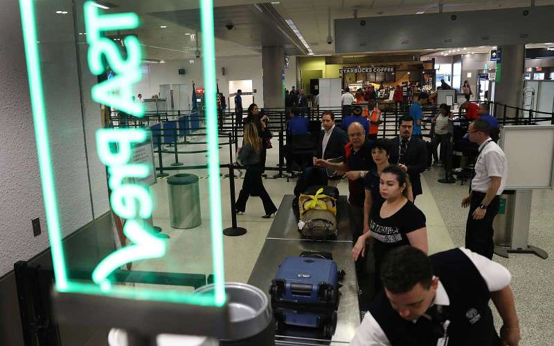 MIAMI, FL - JUNE 02: Travelers go through the TSA Pre-check line at Miami International Airport on June 2, 2016 in Miami, Florida. As the busy summer travel season heats up the Transportation Security Administration is encouraging people to sign up for the TSA Pre-check program to save time going through the airports security lines. Those enrolled in the program can leave their shoes, light outerwear and belt on during the terminal screening process as well as keeping their laptop in the carry-on suitcase without having to remove them at the checkpoint. (Photo by Joe Raedle/Getty Images)
