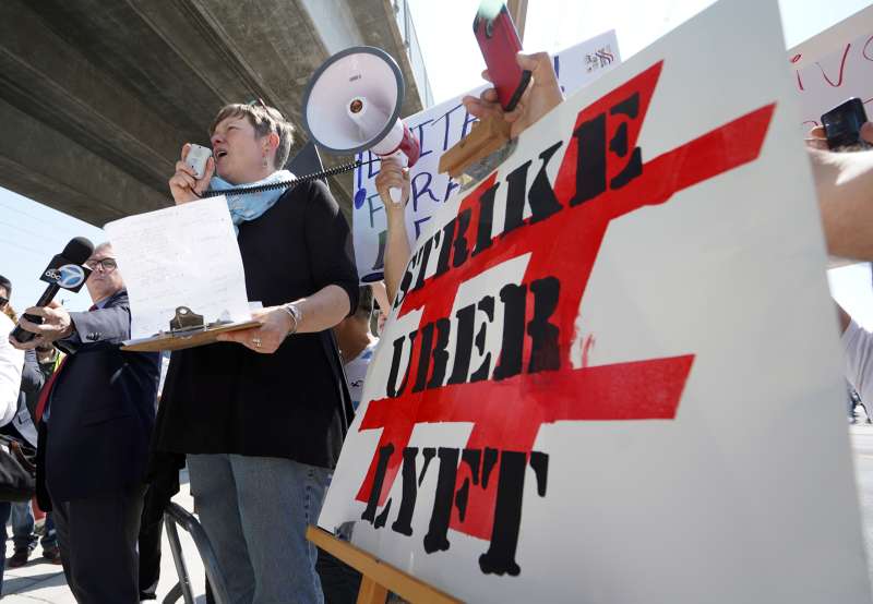 REDONDO BEACH, CA - MARCH 25: Driver and strike organizer Nicole Moore speaks during a one-day strike against Uber and Lyft in front of an Uber office. Over 200 drivers marched with signs and protested a recent 25% deduction in pay for Uber drivers.