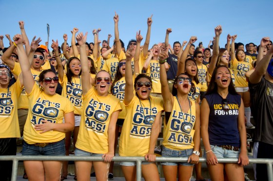 Crowd of students cheer at a sports event at the University of California Davis
