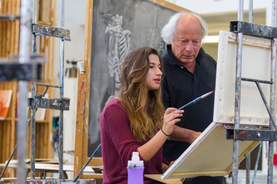 A student panting during an art class at Binghamton University