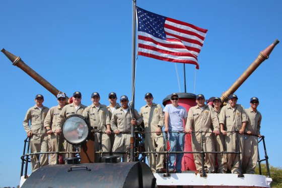 Maritime College students pose in uniform on a ship