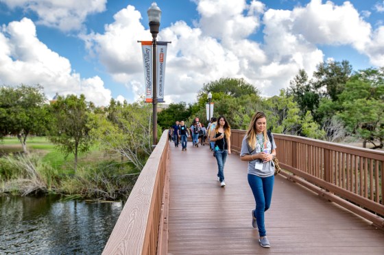 UTRGV students crossing a bridge on campus